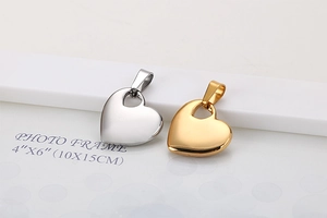 Close-up of gold and silver heart-shaped pendant necklaces with polished metal finish