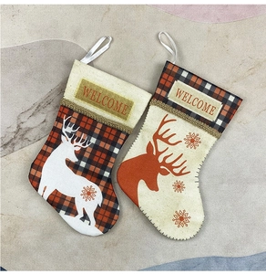 Close-up of small Christmas stockings with reindeer patterns and Welcome labels