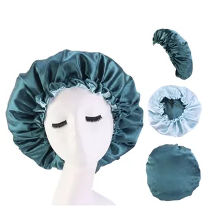 Detail of silk satin durag caps in dark green and light blue for hair care use