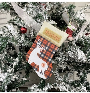 Detail of Christmas stocking with WELCOME embroidery and deer silhouette on tree