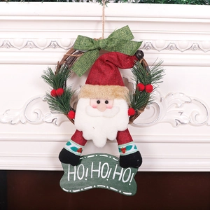 Christmas wreath with Santa Claus doll, red hat, and HO HO HO sign on white fireplace