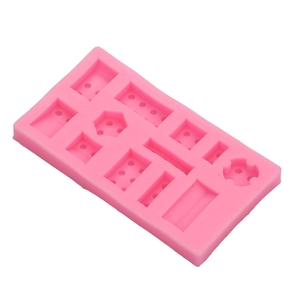 Pink silicone lego block mold for fondant and chocolate baking decorations on white background