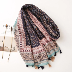 Detail of floral ethnic cotton scarf with tassels and navy blue geometric patterns
