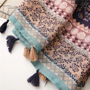 Close-up of ethnic floral cotton scarf showing fringe tassels and woven texture details