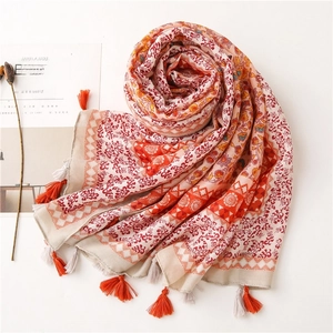 Detailed view of floral printed ethnic scarf with decorative tassels and soft texture