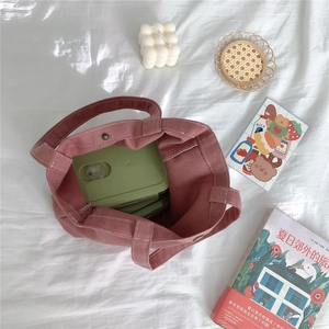 Internal view of pink canvas tote showing spacious capacity with a lunch box inside