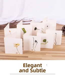 Detail of elegant Chinese style folding cards with lotus illustrations on wood surface