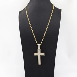 Men hip hop golden Cuban chain with large iced out cross pendant on a black mannequin