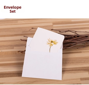 Detail of Chinese style greeting card with lotus design and white paper envelope