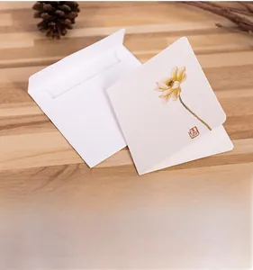 Detail of Chinese style greeting card with lotus illustration on wooden table