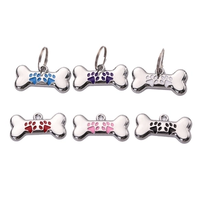Polished bone-shaped metal pet ID tags with colorful paw print designs in six vibrant colors