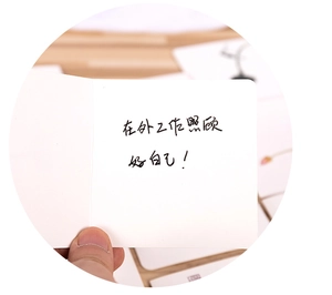Close-up of a white folded greeting card with handwritten heartfelt message inside
