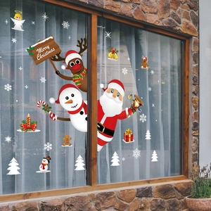 Christmas window decals with Santa, snowman and reindeer on glass window for holiday decor