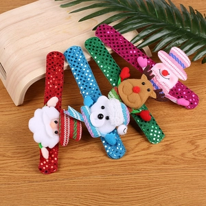 Close-up of four festive Christmas sequin slap bracelets with Santa and reindeer plush figures