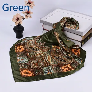 Close-up of a 90cm square silk scarf featuring dark green paisley patterns on books