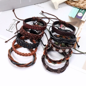 Men's multilayer leather bracelet set with woven straps and star rivets on white background