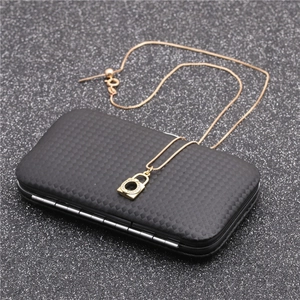 Close-up of a golden padlock pendant necklace with micro-pave zircons on a black jewelry box