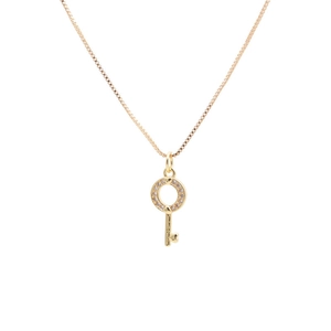 Detail view of a gold key pendant with micro-pave zircons and a small heart on a box chain