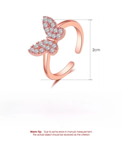 Detail of rose gold butterfly ring with white zircon wings and dimensions shown