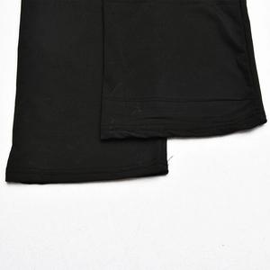 Close-up of black elastic hem stitching on high-quality synthetic sportswear trousers