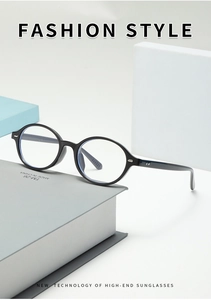 Detail view of oval black frames with silver rivets and blue light coating on books