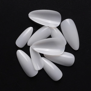 Translucent white almond shaped false nail tips made of ABS plastic on black background