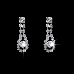 Elegant silver teardrop earrings with crystals and starry glitter effect on black background