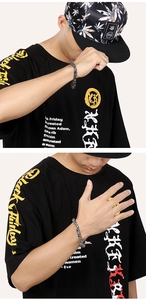 Detail of vintage silver stainless steel king chain bracelet on male model wrist