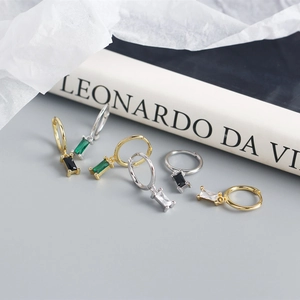Detailed shot of 925 silver hoop earrings with rectangular black green and clear zircons
