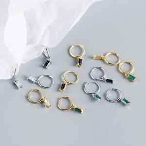 Flat lay of S925 sterling silver geometric huggie earrings with colorful zircon stones