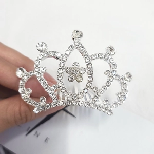 Detailed macro view of silver rhinestone tiara comb with heart and floral motifs