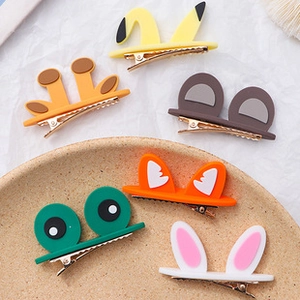 Detail of cute animal-themed hair clips including yellow Pikachu and grey bear designs