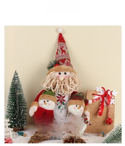 Plush Santa and snowman figures with Merry Christmas sign on white faux fur base
