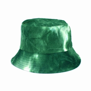 Detail of green tie-dye corduroy texture on the double-sided reversible bucket hat