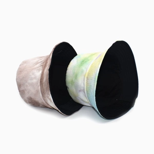 Close-up of tie-dye corduroy bucket hats in earth tones and macaron colors texture detail