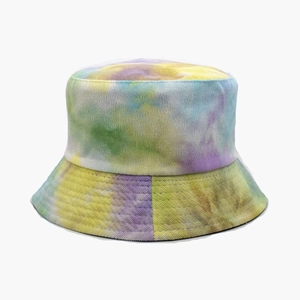 Detailed texture of tie-dye corduroy bucket hat in yellow, purple, blue and green tones