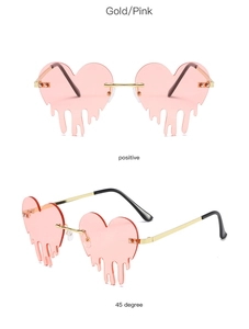 Detail view of heart-shaped melting rimless sunglasses in gold and pink finish