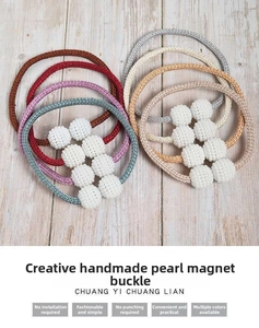 Detail showing woven curtain tiebacks with white pearls and strong magnetic buckle