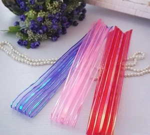 Detail of 5cm organza ribbon bows with metallic laser stripes in purple and pink