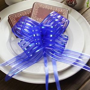 Detail of a large royal blue organza ribbon bow for wedding gift wrap and car decor