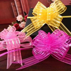 Close-up of pink and gold organza ribbon pull bows for wedding gift wrapping decor