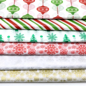 Detailed view of stacked Christmas tissue paper rolls with various festive holiday patterns