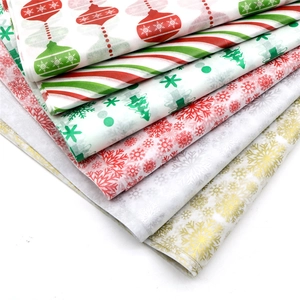 Detail showing various Christmas patterned tissue papers with metallic gold and silver prints
