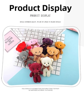 Macro shot of colorful plush teddy bear keychains with Love ribbon bows on display