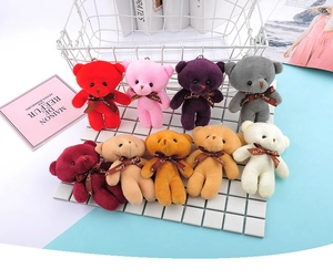 Macro shot of colorful plush teddy bear charms with Love ribbons for keychains