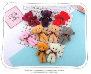Macro shot of colorful plush teddy bear keychains with metal chains and Love ribbons
