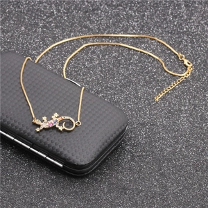 Women's gold gecko necklace with micro-pave colorful zircon stones on black background