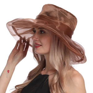 Detail of elegant brown organza sun hat featuring wide pleated brim and metallic luster