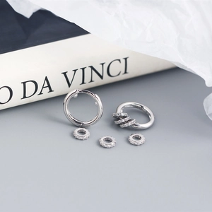 Close-up of S925 sterling silver hoop earrings with detachable pavé cubic zirconia charms