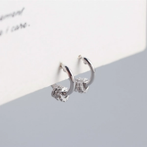 Macro detail of S925 sterling silver hoop earrings with three detachable crystal rings